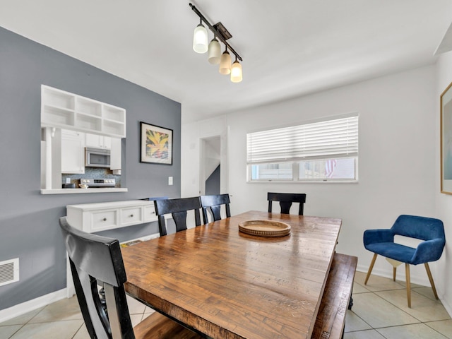 92 Tarpon St, Destin, FL 32541 - dining room featuring light tile patterned floors and track lighting