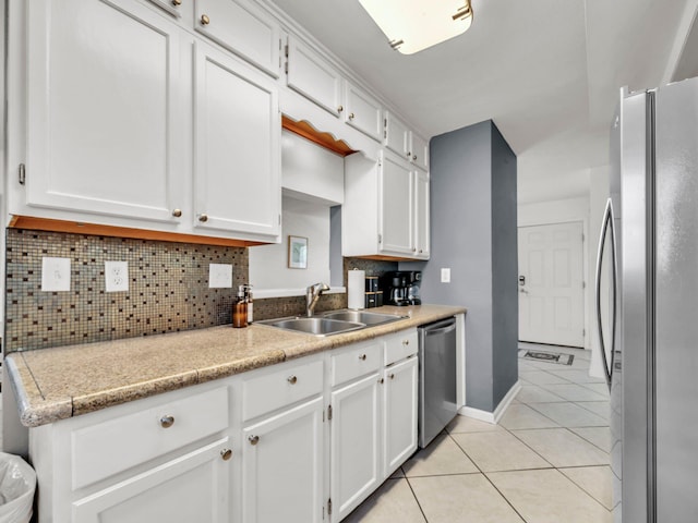92 Tarpon St, Destin, FL 32541 - kitchen with appliances with stainless steel finishes, light tile patterned flooring, white cabinets, and tasteful backsplash