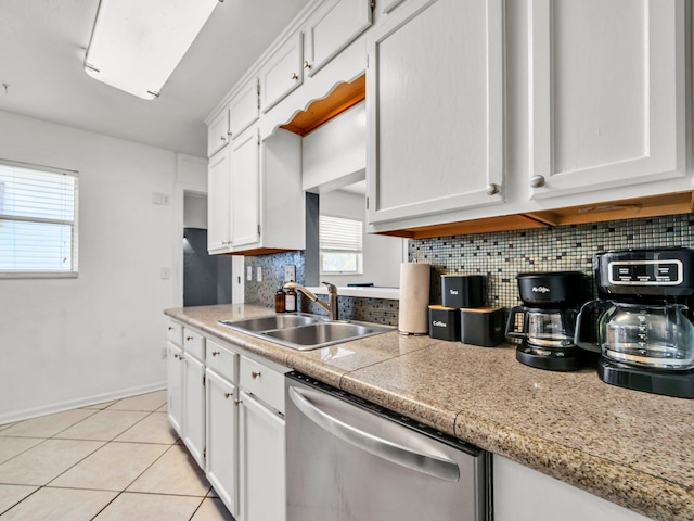 92 Tarpon St, Destin, FL 32541 - kitchen featuring dishwasher, tasteful backsplash, white cabinets, light tile patterned floors, and light countertops