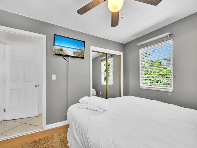 92 Tarpon St, Destin, FL 32541 - bedroom featuring wood finished floors, a closet, ceiling fan, and multiple windows