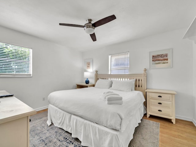 92 Tarpon St, Destin, FL 32541 - bedroom featuring multiple windows, light wood-style floors, and a ceiling fan