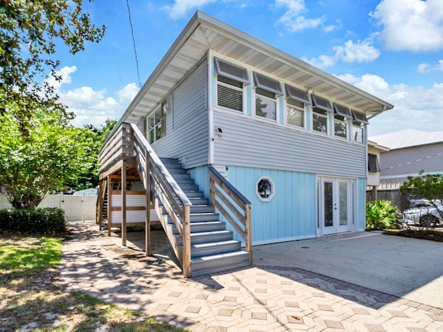 92 Tarpon St, Destin, FL 32541 - back of house featuring french doors, stairs, a gate, and a patio area