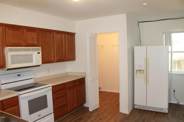 1802 Shay-Lin Ct, Niceville, FL 32578 - kitchen featuring white appliances, dark wood finished floors, brown cabinets, and light countertops