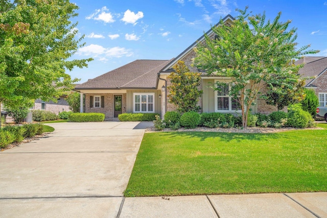 129 Meadow Lake Dr, Freeport, FL 32439 - traditional-style house featuring driveway, brick siding, and a front yard