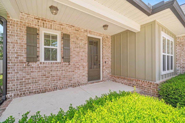 129 Meadow Lake Dr, Freeport, FL 32439 - entrance to property with board and batten siding, covered porch, and brick siding