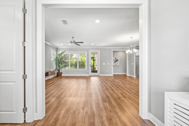 129 Meadow Lake Dr, Freeport, FL 32439 - unfurnished living room with crown molding, light wood-style flooring, ceiling fan, a chandelier, and recessed lighting