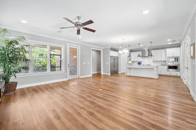 129 Meadow Lake Dr, Freeport, FL 32439 - unfurnished living room featuring a chandelier, ornamental molding, a ceiling fan, light wood finished floors, and recessed lighting