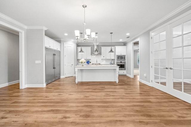 129 Meadow Lake Dr, Freeport, FL 32439 - kitchen with built in appliances, a chandelier, ornamental molding, light countertops, and decorative backsplash