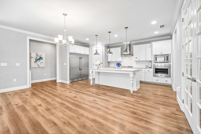 129 Meadow Lake Dr, Freeport, FL 32439 - kitchen featuring built in appliances, light countertops, a chandelier, a breakfast bar, and crown molding