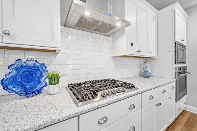 129 Meadow Lake Dr, Freeport, FL 32439 - kitchen with exhaust hood, stainless steel appliances, white cabinetry, and dark wood-type flooring