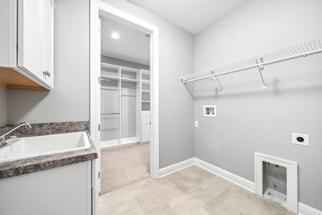 129 Meadow Lake Dr, Freeport, FL 32439 - laundry area featuring electric dryer hookup, cabinet space, and washer hookup
