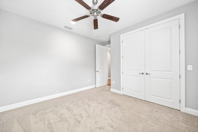 129 Meadow Lake Dr, Freeport, FL 32439 - unfurnished bedroom with light colored carpet, a closet, and ceiling fan