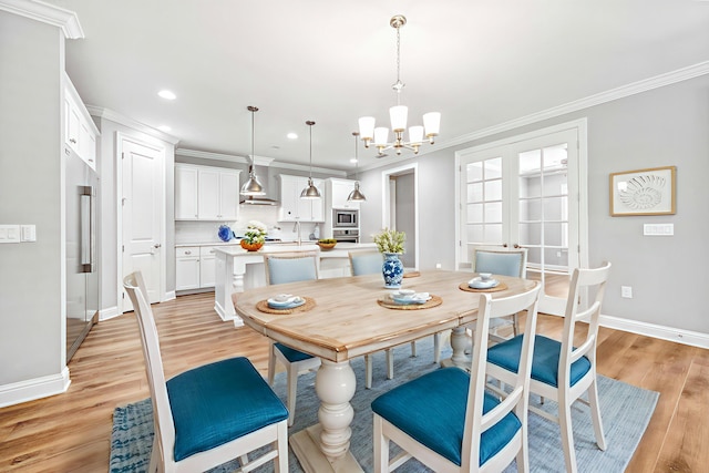 129 Meadow Lake Dr, Freeport, FL 32439 - dining space with a chandelier, crown molding, light wood finished floors, and recessed lighting