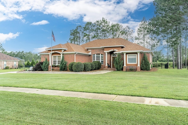 180 Gulf Pines Ct, Freeport, FL 32439 - single story home featuring brick siding, a front yard, and a shingled roof
