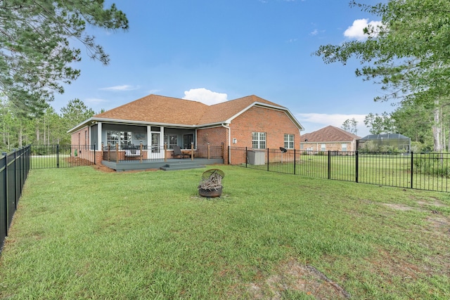 180 Gulf Pines Ct, Freeport, FL 32439 - back of house featuring brick siding, a sunroom, an outdoor fire pit, and a fenced backyard