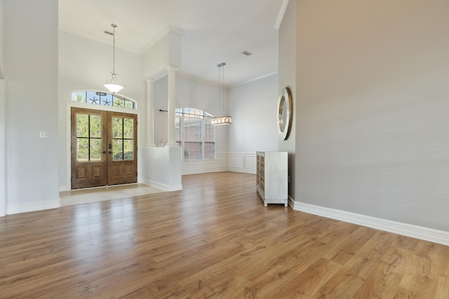 180 Gulf Pines Ct, Freeport, FL 32439 - foyer entrance featuring crown molding, a towering ceiling, french doors, and light wood-type flooring