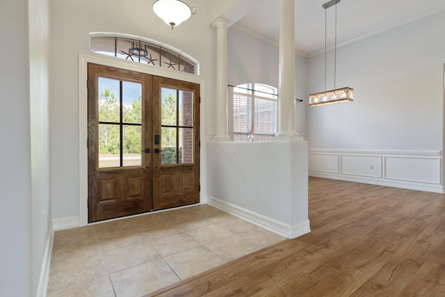 180 Gulf Pines Ct, Freeport, FL 32439 - entryway with french doors, crown molding, light wood finished floors, and decorative columns