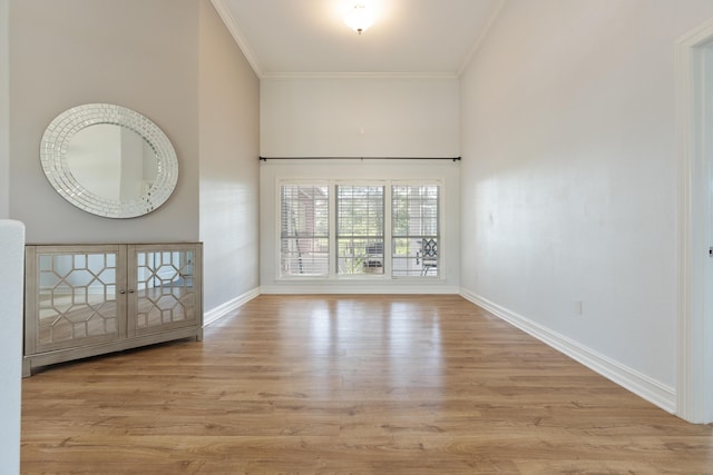 180 Gulf Pines Ct, Freeport, FL 32439 - empty room with crown molding, wood finished floors, and a high ceiling