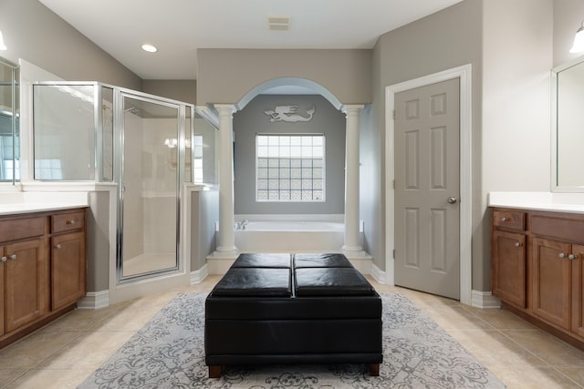 180 Gulf Pines Ct, Freeport, FL 32439 - bathroom with ornate columns, vanity, a stall shower, a garden tub, and recessed lighting