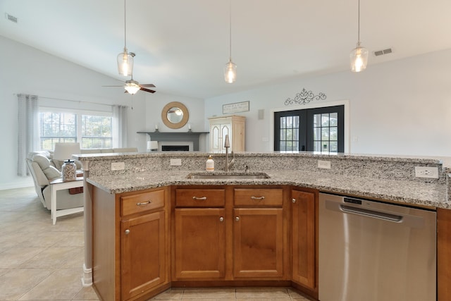 180 Gulf Pines Ct, Freeport, FL 32439 - kitchen with stainless steel dishwasher, open floor plan, a ceiling fan, and brown cabinets