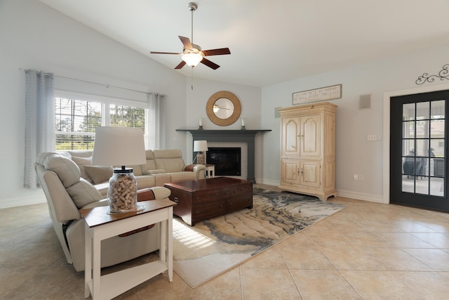 180 Gulf Pines Ct, Freeport, FL 32439 - living room featuring ceiling fan, vaulted ceiling, light tile patterned floors, and a glass covered fireplace