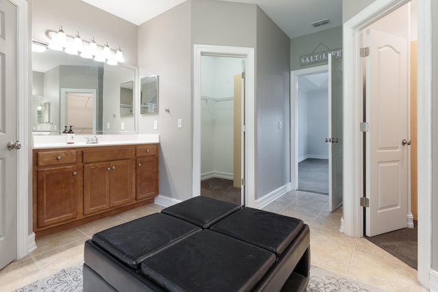 180 Gulf Pines Ct, Freeport, FL 32439 - bathroom with tile patterned floors, vanity, and a walk in closet