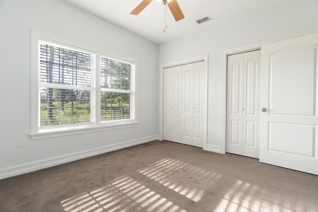 180 Gulf Pines Ct, Freeport, FL 32439 - unfurnished bedroom featuring carpet flooring, multiple closets, and a ceiling fan