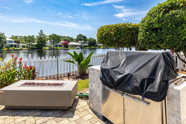 2077 Olde Towne Ave, Miramar Beach, FL 32550 - view of patio featuring an outdoor fire pit, a water view, and a grill