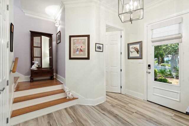 2077 Olde Towne Ave, Miramar Beach, FL 32550 - entrance foyer featuring crown molding, a chandelier, light wood-style floors, and stairs