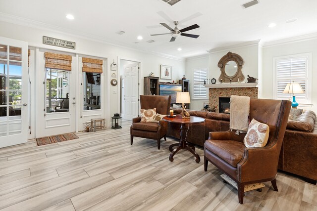 2077 Olde Towne Ave, Miramar Beach, FL 32550 - living area featuring a glass covered fireplace, a ceiling fan, plenty of natural light, recessed lighting, and crown molding