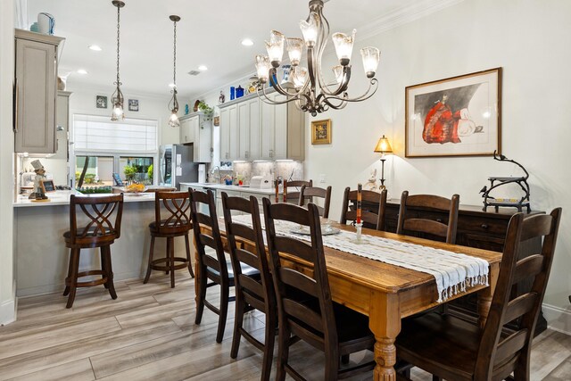 2077 Olde Towne Ave, Miramar Beach, FL 32550 - dining room with crown molding, light wood finished floors, a chandelier, and recessed lighting