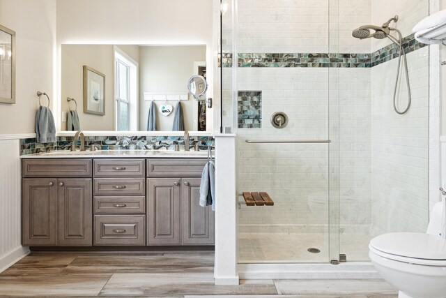 2077 Olde Towne Ave, Miramar Beach, FL 32550 - bathroom featuring a stall shower, double vanity, and wood finished floors