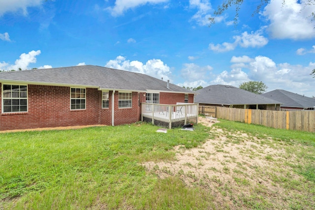 653 Territory Ln, Crestview, FL 32536 - rear view of property featuring a deck, brick siding, and roof with shingles