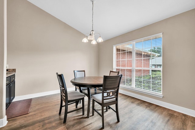 653 Territory Ln, Crestview, FL 32536 - dining area featuring healthy amount of natural light, dark wood finished floors, lofted ceiling, and a chandelier