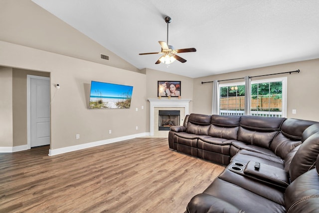 653 Territory Ln, Crestview, FL 32536 - living area with ceiling fan, wood finished floors, vaulted ceiling, and a fireplace