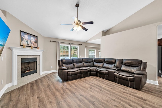 653 Territory Ln, Crestview, FL 32536 - living room with vaulted ceiling, ceiling fan, wood finished floors, and a tile fireplace