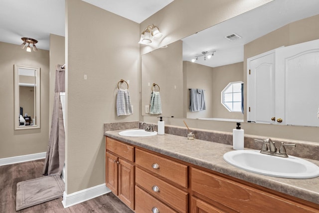 653 Territory Ln, Crestview, FL 32536 - full bathroom featuring double vanity, wood finished floors, and a shower with curtain