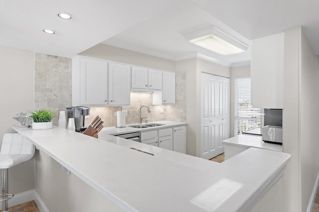 114 Mainsail Dr Unit 143, Miramar Beach, FL 32550 - kitchen featuring light countertops, recessed lighting, white cabinetry, backsplash, and ornamental molding