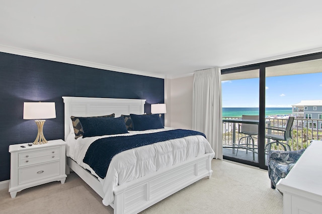 114 Mainsail Dr Unit 143, Miramar Beach, FL 32550 - bedroom featuring light colored carpet, access to outside, a water view, crown molding, and expansive windows