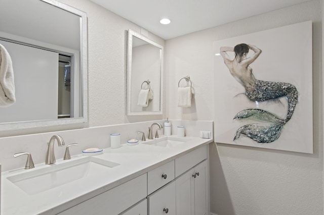 114 Mainsail Dr Unit 143, Miramar Beach, FL 32550 - bathroom featuring double vanity and a textured wall