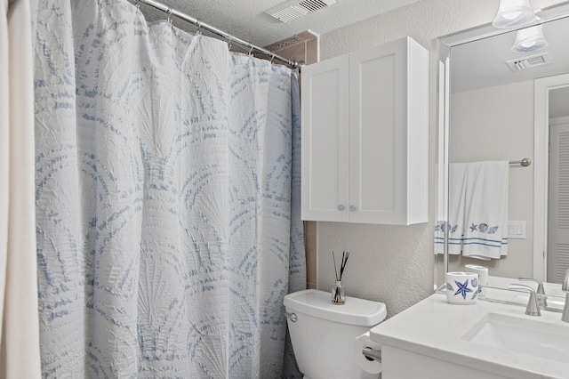 114 Mainsail Dr Unit 143, Miramar Beach, FL 32550 - bathroom featuring a textured wall, vanity, and a shower with curtain