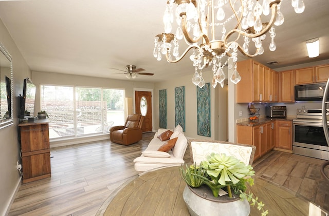 52 NE Iowa Dr, Fort Walton Beach, FL 32548 - kitchen with stainless steel electric range, black microwave, ceiling fan, and a chandelier