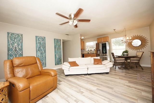 52 NE Iowa Dr, Fort Walton Beach, FL 32548 - living area with ceiling fan, light wood finished floors, and a chandelier