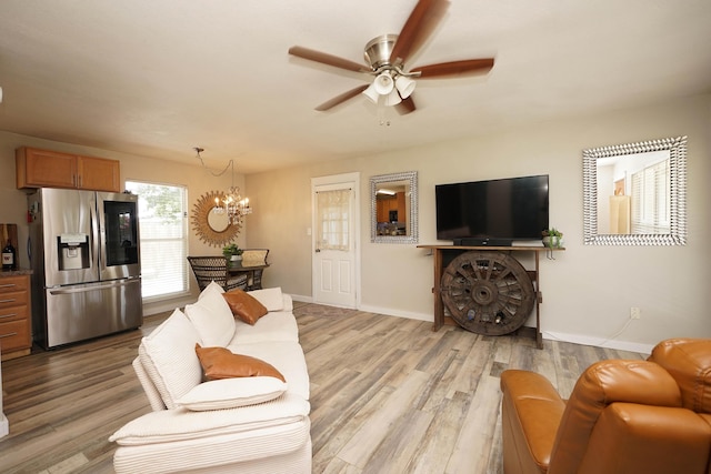 52 NE Iowa Dr, Fort Walton Beach, FL 32548 - living room featuring a chandelier, ceiling fan, and light wood-style floors