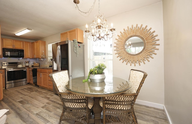 52 NE Iowa Dr, Fort Walton Beach, FL 32548 - dining room featuring light wood finished floors and a chandelier