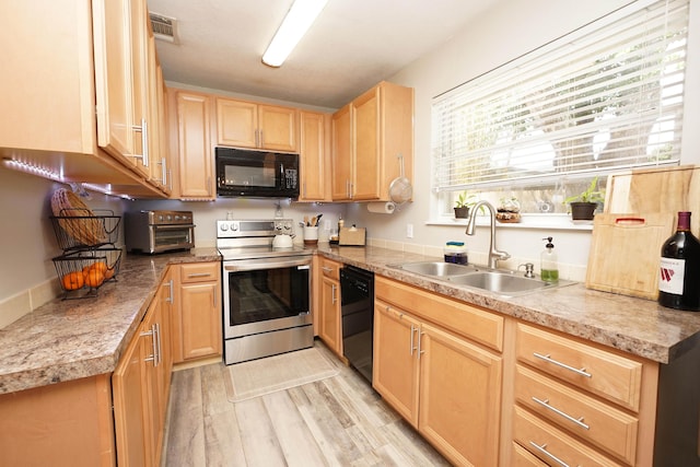 52 NE Iowa Dr, Fort Walton Beach, FL 32548 - kitchen featuring black appliances, light brown cabinetry, light wood-type flooring, and light countertops