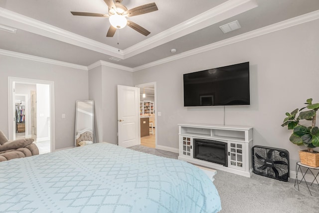 1922 Frontera St, Navarre, FL 32566 - carpeted bedroom with a raised ceiling, ornamental molding, ceiling fan, and a glass covered fireplace