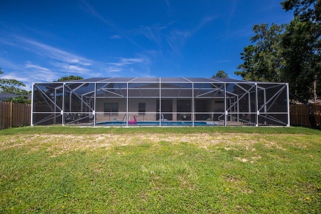 1922 Frontera St, Navarre, FL 32566 - rear view of house featuring a fenced backyard and glass enclosure