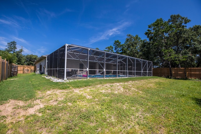 1922 Frontera St, Navarre, FL 32566 - back of property with a fenced backyard, glass enclosure, and an outdoor pool