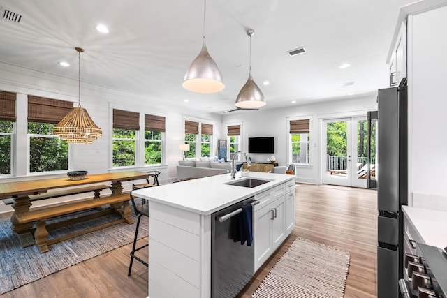 213 Spotted Dolphin Rd, Santa Rosa Beach, FL 32459 - kitchen with dishwashing machine, open floor plan, light countertops, light wood finished floors, and recessed lighting